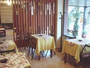 圣拉斐尔大理酒店的餐厅设有两张带黄桌布的桌子