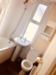 罗奇福德AC Lounge 125的一间带卫生间、水槽和窗户的浴室