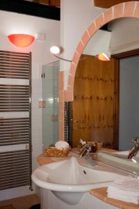 特雷尼亚戈B&B Antico Borgo Marcemigo的一间带水槽和镜子的浴室