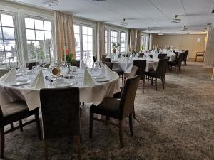 GranSanner Hotell的宴会厅配有桌椅和窗户。
