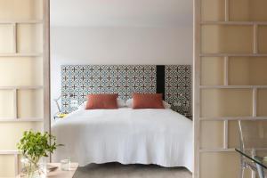 哥本哈根Eric Vökel Boutique Apartments - Copenhagen Suites的卧室配有白色的大床和架子