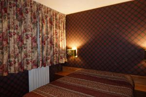 FaidelloSuite sulle piste的一间酒店客房,配有两张床和窗帘