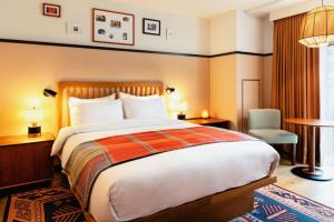 华盛顿哥伦比亚区伊顿酒店的酒店客房带一张大床和一把椅子
