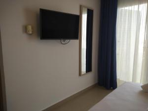 埃斯普霍斯罗卡贝拉酒店的卧室的墙上设有平面电视