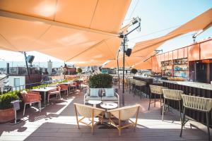 苏黎世Storchen Zürich - Lifestyle boutique Hotel的一个带桌椅和遮阳伞的屋顶露台