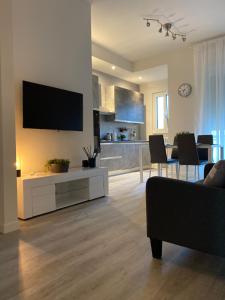 曼托瓦Residenza Bonomi 23的客厅配有沙发和墙上的电视