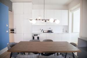 里斯本FLH Augusta's Arch Design Apartment的厨房配有木制餐桌和椅子
