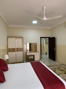 索哈尔Sama Sohar Hotel Apartments - سما صحار للشقق الفندقية的一间卧室配有一张大床和一张书桌