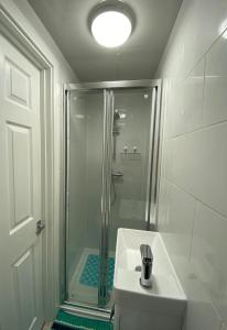 WembleyStadium Nook的带淋浴和盥洗盆的白色浴室