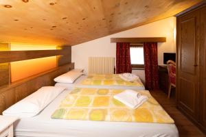 利维尼奥Residence San Marco by Alpenwhite的配有木天花板的客房设有两张床。
