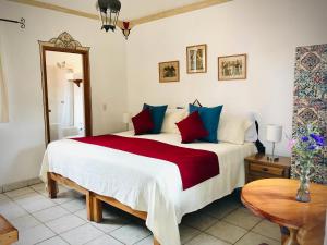阿吉吉克卡萨布兰卡酒店的一间卧室配有一张带红色和蓝色枕头的大床