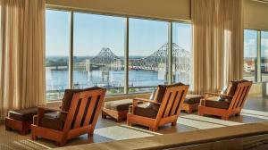 圣路易斯圣路易斯四季酒店的一间设有三把椅子的客房,享有桥梁的景色