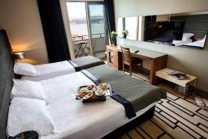 伊斯坦布尔吉汉吉尔酒店的酒店客房设有一张大床,上面放着一盘食物