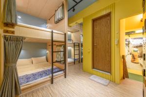 三星乡山多香青年民宿 Santhosham Hostel的带门的房间设有两张双层床