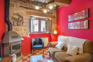 Casas del MonteCASA RURAL ARBEQUINA, Primavera en el Valle del Ambroz的带沙发和壁炉的客厅