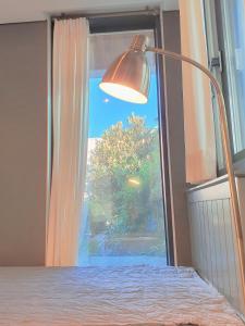 木浦市Picasso Guesthouse的一间卧室配有床、灯和窗户
