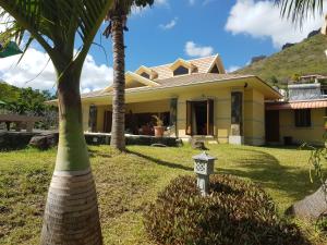 勒莫尔尼La Villa Marie Joana的院子里有棕榈树的黄色房子