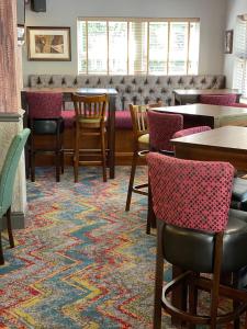Liversedge利弗西奇酒店的用餐室配有桌椅和地毯。