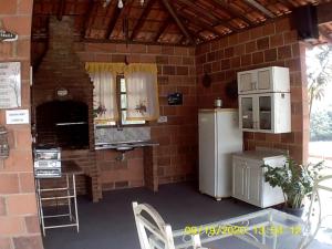 布拉干萨-保利斯塔Terras de Bragança的厨房配有冰箱和砖墙