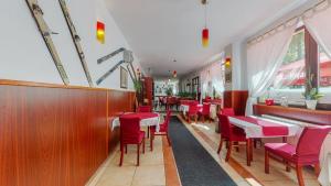 代尔尼采普拉尼纳斯基辛塔尔佩特赫瓦斯酒店的餐厅内带红色椅子和桌子的用餐室