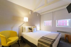 波尔图Stay in Apartments Ribeira 24的酒店客房,配有床和黄色椅子