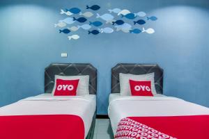 北柳OYO 428 Pha Mansion的墙上有鱼的房间,设有两张床