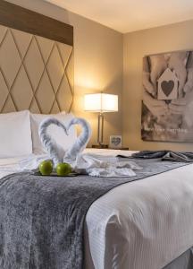 基西米Palazzo Lakeside Hotel的酒店客房,配有一张带两条心形毛巾的床