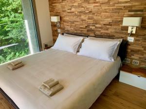 阿夸拉尼亚La Forestale Luxury Ecolodge B&B Primo Piano的一间卧室配有一张大床和两条毛巾