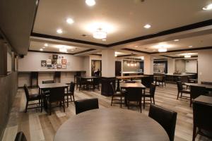 斯波坎Oxford Suites Spokane Downtown的餐厅内带桌椅的用餐室