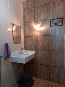 安娜兰迪亚Recanto Pousada Sonho Meu的一间带水槽和木墙的浴室