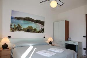 阿祖罗港旺达别墅酒店的一间卧室配有一张床,上面有两条毛巾