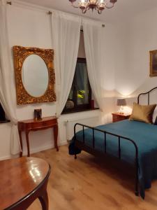 比得哥什Apartment lux gimnazjalna的一间卧室配有一张床、镜子和一张桌子
