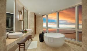 海口海口华彩洲际酒店的一间带两个盥洗盆的浴室和一个大窗户