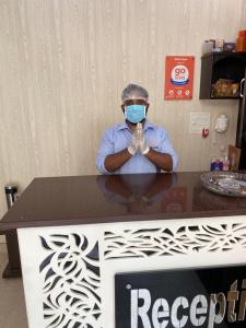 哈里瓦Hotel Gopal的戴面具的人坐在桌子上