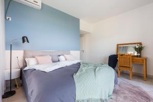 三亚三亚阳光海景公寓的一间卧室配有一张蓝色墙壁的床