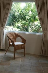 鹅銮鼻窝在海边民宿的坐在大窗户前的藤椅