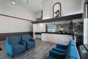 米德瓦尔Quality Inn Midvale - Salt Lake City South的一间设有蓝色椅子和镜子的等候室