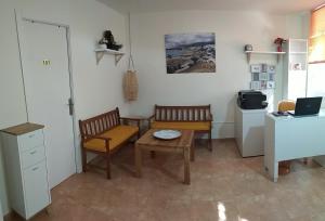 圣伊西德罗Kiki vivienda Bed & breakfast的厨房配有两把椅子、一张桌子和一台冰箱