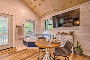 布罗肯鲍Romantic Broken Bow Cabin with Jacuzzi and Fire Pit!的厨房配有桌子和浴缸。