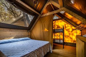 卡斯蒂里昂纳·德拉佩Camping Internazionale Etruria的树屋的卧室,里面设有床