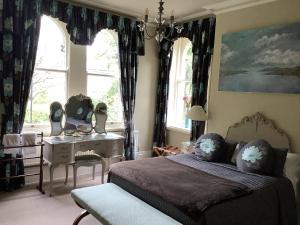 哈罗盖特Alexandra Court的卧室配有一张床、一张书桌和窗户。