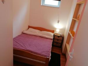 Gornje VratnoApartman Obadić的一间小卧室,配有床和床头柜