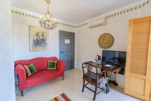 Los Romanes西班牙拉斯奥奎迪斯酒店的客厅配有红色沙发和书桌