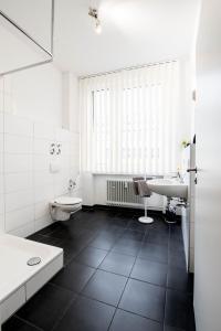 阿伦Apartmenthaus Aalen的白色的浴室设有水槽和卫生间。
