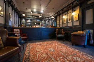 吉尔福德沃普莱斯顿广场酒店的一间酒吧,酒吧配有椅子和地毯