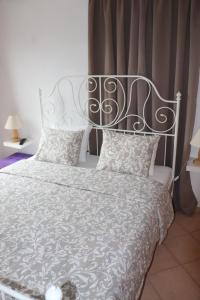 美特索文Baou House 1的一间带白色床和金属床头的卧室