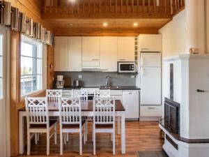 拉赫登佩拉Holiday Home Otava by Interhome的厨房配有桌椅和冰箱。