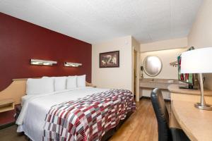 兰霍恩费城红屋顶酒店 - 牛津谷的配有一张床和一张书桌的酒店客房