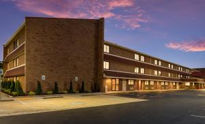 哥伦布Red Roof Inn PLUS+ Columbus - Worthington的砖楼前的一个空停车位