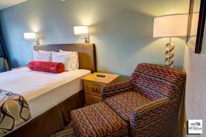 弗洛伦斯古城汽车旅馆的配有一张床和一把椅子的酒店客房